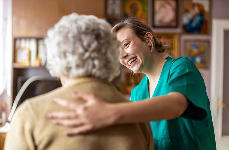 Resident and family member review a care plan and rights information at an assisted living table.